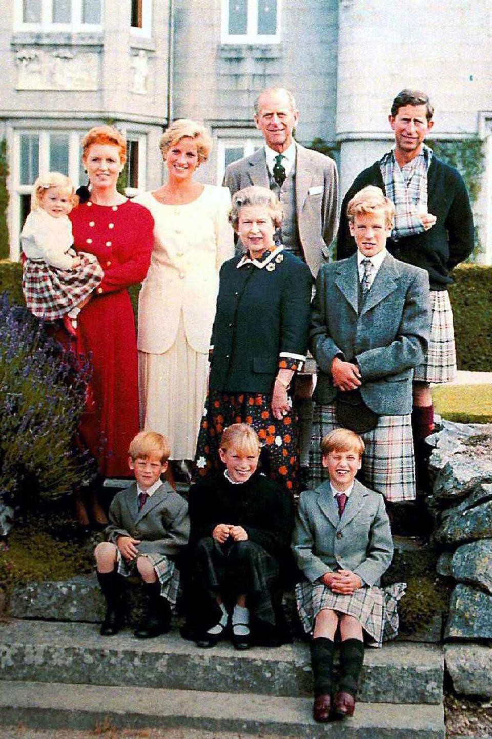 Changing times: And with later generations at Balmoral with Sarah, the Duchess of York holding Princess Beatrice, Princess Diana, Pince Philip, Peter Phillips and Prince Charles. Seated are Prince Harry, Zara Phillips and Prince William (Rex Features)