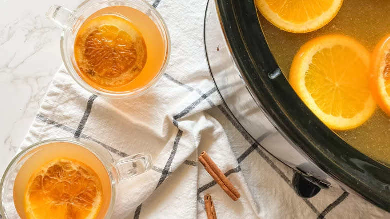Cider pot and glasses with orange slices