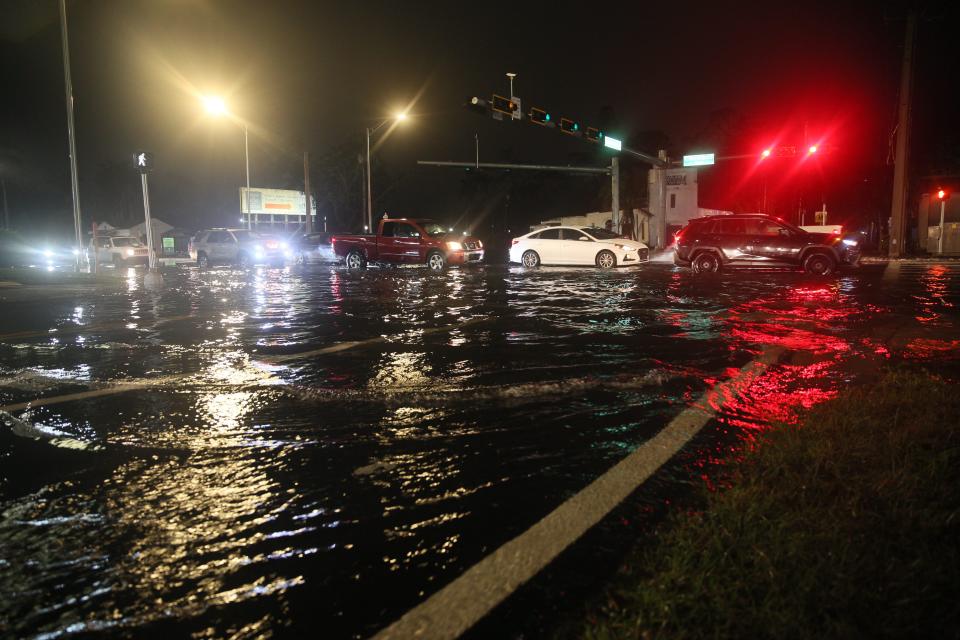 Traffic navigates flooded streets in Fort Myers on Monday, Jan. 15, 2024. Parts of Cape Coral, North Fort Myers and Fort Myers saw a deluge of rain over a short period of time this evening.