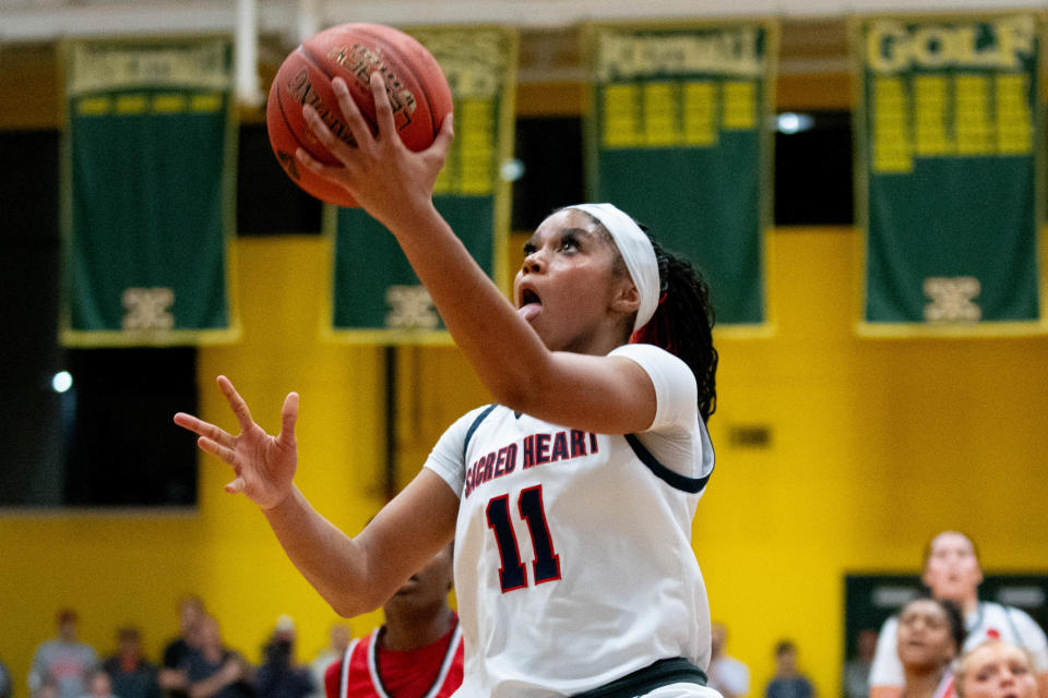 Sacred Heart's ZaKiyah Johnson (11) goes for a layup during their game against George Rogers Clark on Friday, Feb. 9, 2024 at St. Xavier High School
