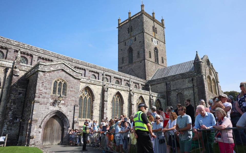 Members of the public are seen ahead of the arrival of the Prince and Princess of Wales on the first anniversary of Queen Elizabeth II death at St. Davids Cathedral