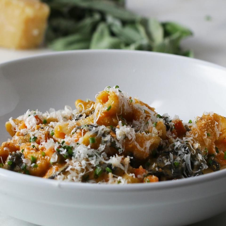 Bowl of penne topped with Parmesan cheese