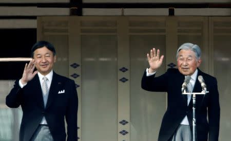 Japanese Emperor Akihito (R) and Crown Prince Naruhito wave to well-wishers during a public appearance for New Year celebrations at the Imperial Palace in Tokyo, Japan, January 2, 2017. REUTERS/Kim Kyung-Hoon/Files