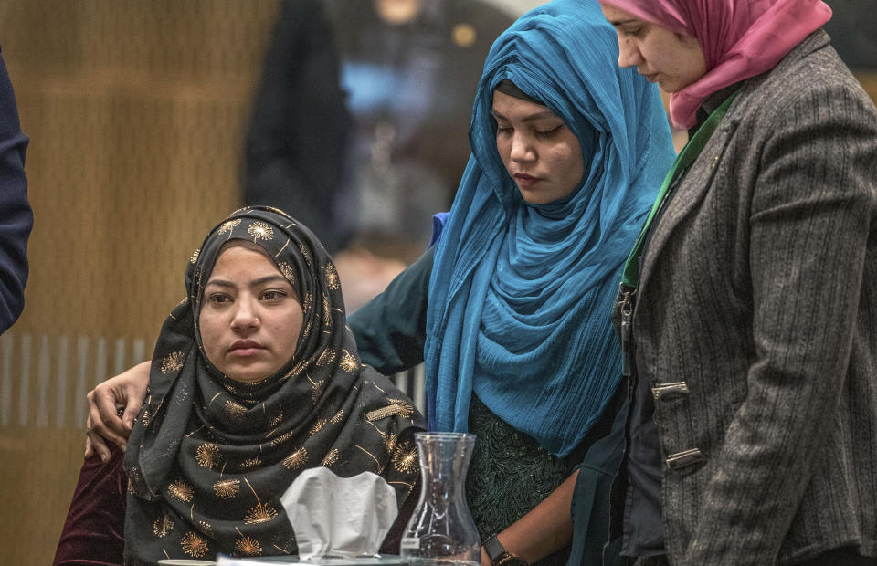 Sazada Akhter, left, is consoled as she gives her impact statement during the sentencing hearing for Australian Brenton Harrison Tarrant at the Christchurch High Court after Tarrant pleaded guilty to 51 counts of murder, 40 counts of attempted murder and one count of terrorism in Christchurch, New Zealand, Wednesday, Aug. 26, 2020. More than 60 survivors and family members will confront the New Zealand mosque gunman this week when he appears in court to be sentenced for his crimes in the worst atrocity in the nation's modern history. (John Kirk-Anderson/Pool Photo via AP)