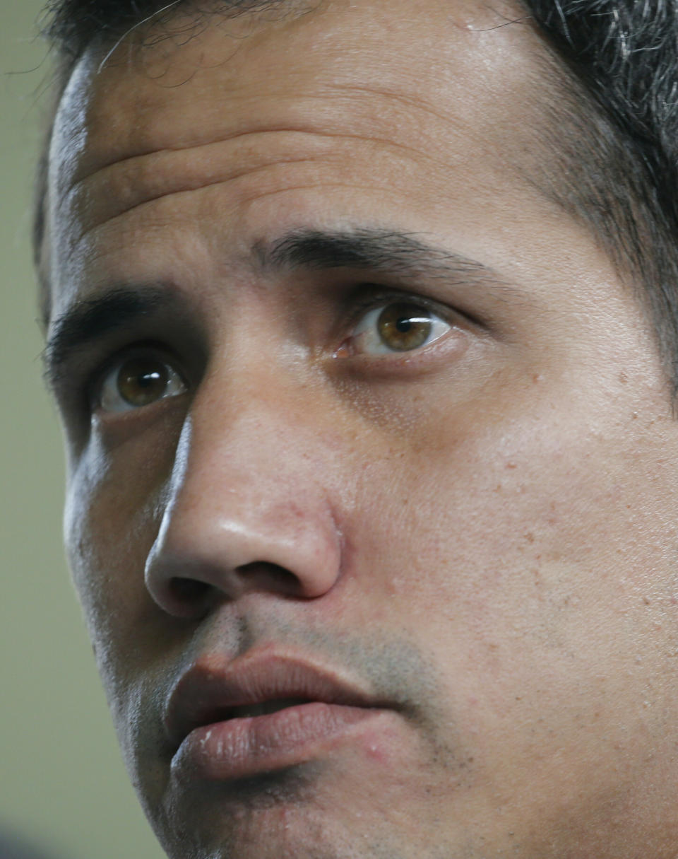 CORRECTS PHOTOGRAPHER'S BYLINE - Opposition leader Juan Guaido, who has declared himself interim president of the country, attends a press conference at a school where he delivered humanitarian aid, in Caracas, Venezuela, Thursday, March 21, 2019. Guaido says the Venezuelan government is weak and doesn't "dare" to detain him. Guaido spoke Thursday after intelligence agents staged an overnight raid and detained Roberto Marrero, his key aide. (AP Photo/Ariana Cubillos)