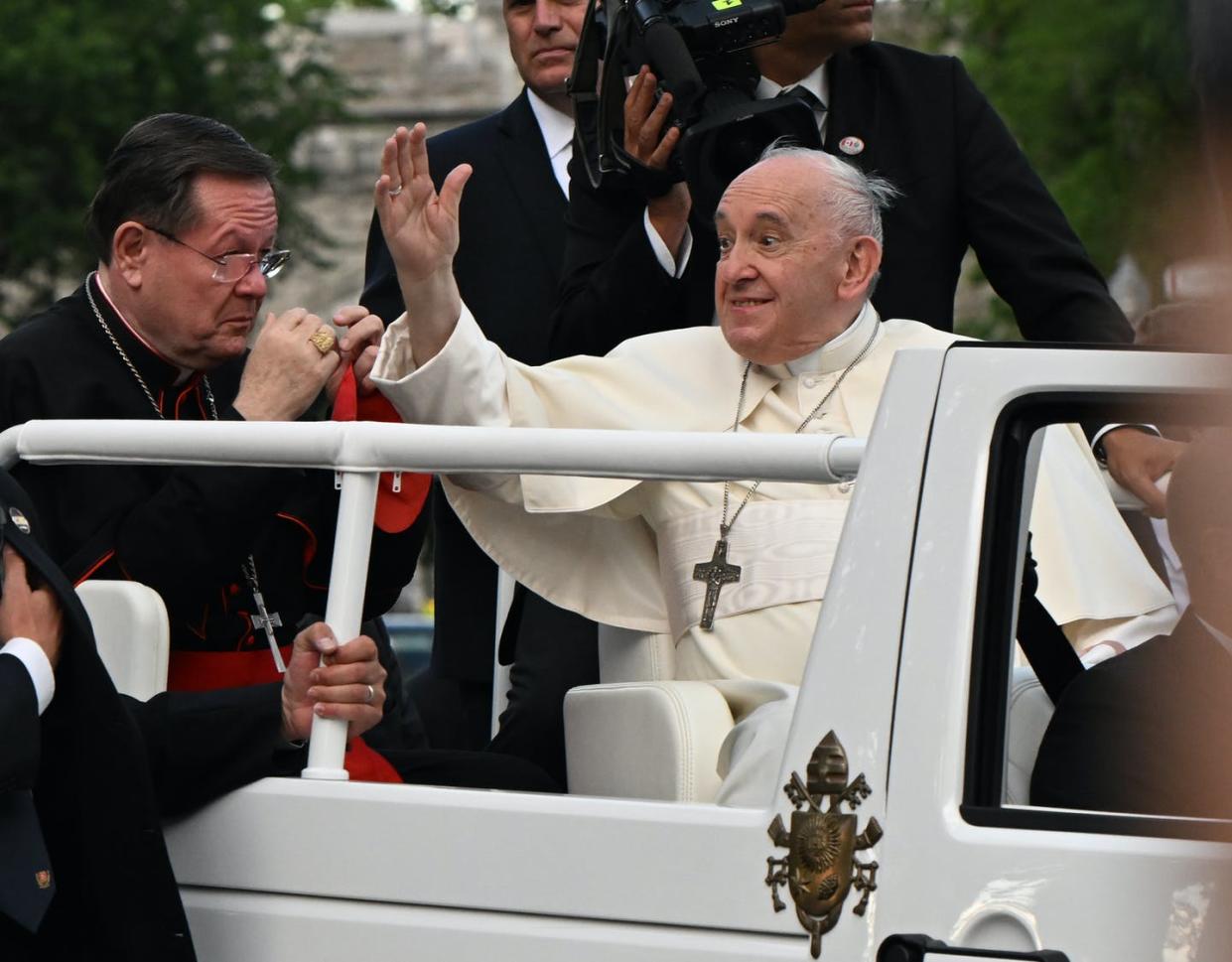 Pope Francis waves to the crowd, making his way to the Plains of Abraham during his Papal visit in Québec City on July 27, 2022. THE CANADIAN PRESS/Jacques Boissinot