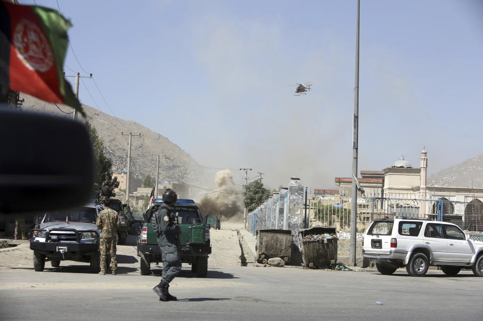 An MD 530F military helicopter targets a house where attackers are hiding in Kabul, Afghanistan, Tuesday, Aug. 21, 2018. The Taliban fired rockets toward the presidential palace in Kabul Tuesday as President Ashraf Ghani was giving his holiday message for the Muslim celebrations of Eid al-Adha, said police official Jan Agha. (AP Photo/Rahmat Gul)