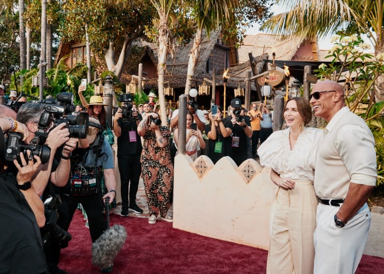 Anaheim, CA - 7/24/21: Emily Blunt and Dwayne Johnson exit the Jungle Cruise ride and pose for photographers on the red carpet for the premiere of the new film Disney's Jungle Cruise Saturday, July 24, 2021 in Disneyland. (PHOTOGRAPH BY ADAM AMENGUAL / FOR THE TIMES)