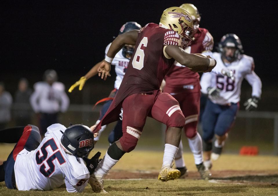 (55) grabs ahold of Jamarkus Jefferson (6)'s jersey, but he slips the tackle for a big pick up during the Bozeman vs Northview playoff football game at Northview High School on Friday, Nov. 12, 2021