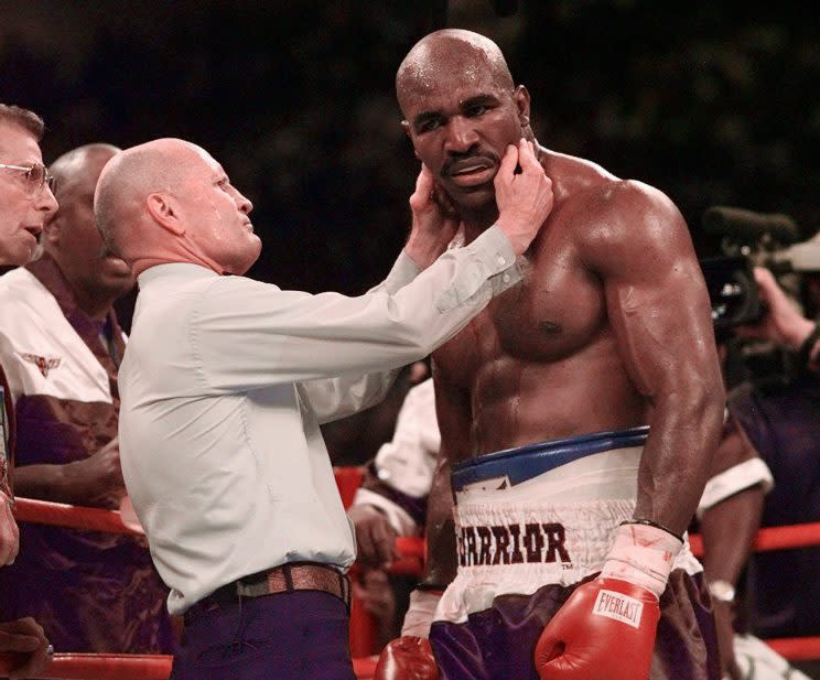 Evander Holyfield has his right ear checked by referee Mills Lane after he was bit in the ear by Mike Tyson in the third round of their WBA Heavyweight match Saturday, June 28, 1997, at the MGM Grand in Las Vegas. (AP Photo/Mark J. Terrill)