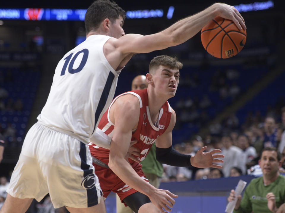 Penn State's Andrew Funk (10) attempts to bounce an out of bounds ball off Wisconsin's Connor Essegian (3) during the first half of an NCAA college basketball game, Wednesday, Feb. 8, 2023, in State College, Pa. (AP Photo/Gary M. Baranec)