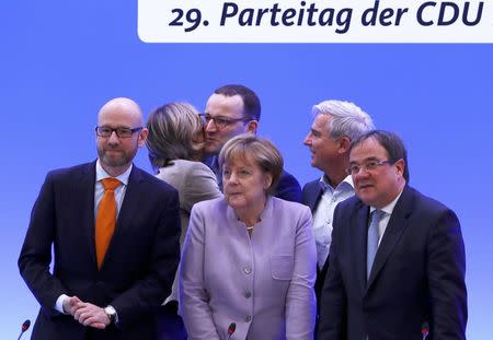 German Chancellor and leader of the conservative Christian Democratic Union party CDU Angela Merkel (C) poses with CDU leaders ahead a CDU party convention in Essen, Germany, December 5, 2016. REUTERS/Wolfgang Rattay