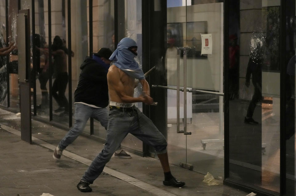 Manifestantes atacan un edificio en el centro de la Ciudad de Guatemala durante un paro nacional, el lunes 9 de octubre de 2023. La gente protesta para apoyar al presidente electo Bernardo Arévalo después de que el máximo tribunal del país confirmó una medida de los fiscales para suspender su partido político por presunto fraude en el registro de votantes. (Foto AP/Moisés Castillo)