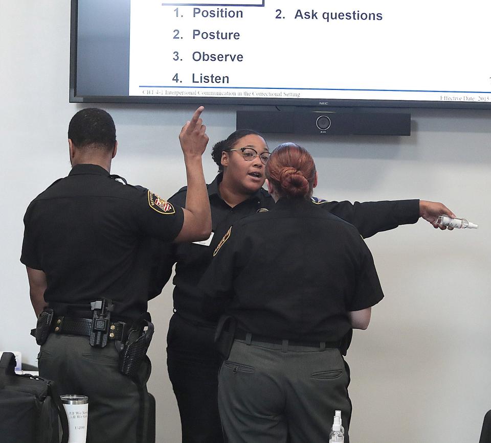 A group of cadets engage in a verbal de-escalation drill Wednesday at the Stark County Law Enforcement Training Center. A four-week corrections officer academy started Monday.