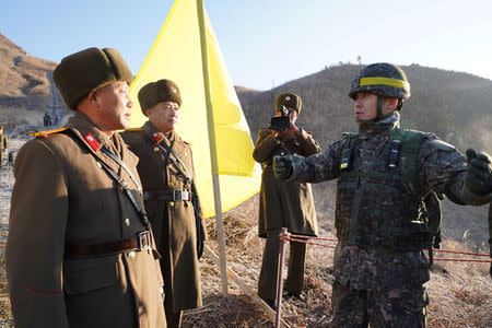 Soldiers from North and South Korea verify the removal of guard posts on each side of the Demilitarized Zone, December 12, 2018. South Korean Defence Ministry/Handout via REUTERS