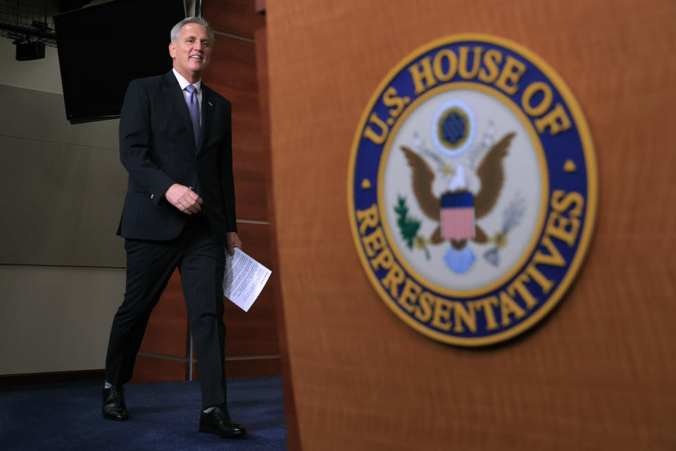 House Minority Leader Kevin McCarthy walks toward a podium.