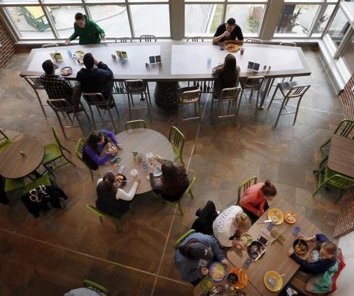 Students at the University of New Hampshire have lunch at the new ,000 custom-made chef's table, top, at the campus dining hall Friday April 29, 2016 in Durham, N.H.  The University of New Hampshire now acknowledges that spending ,000 on a custom-made chef's table with LED lights for the campus dining hall was a mistake. (AP Photo/Jim Cole)