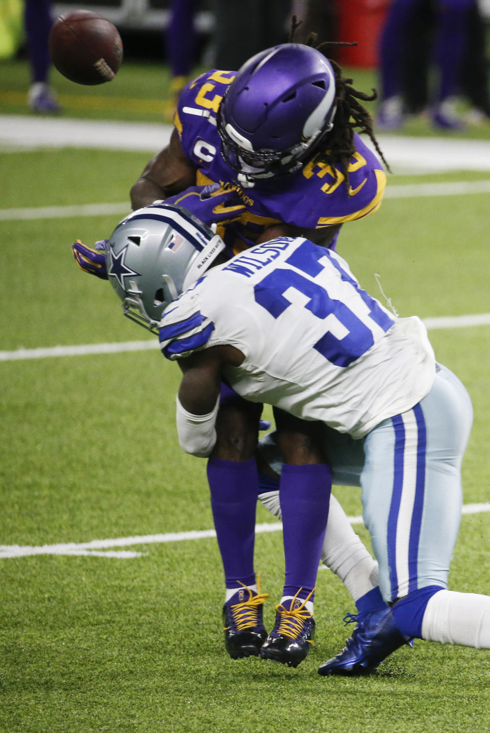 Minnesota Vikings running back Dalvin Cook (33) fumbles as he is hit by Dallas Cowboys safety Donovan Wilson (37) during the first half of an NFL football game, Sunday, Nov. 22, 2020, in Minneapolis. (AP Photo/Bruce Kluckhohn)