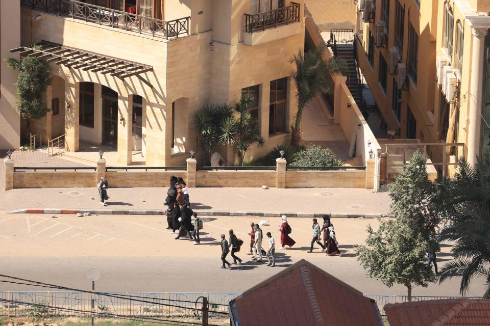 Palestinian families with their belongings flee following the Israeli army's warning to leave their homes and move south before an expected ground offensive, in Gaza City on October 13, 2023.