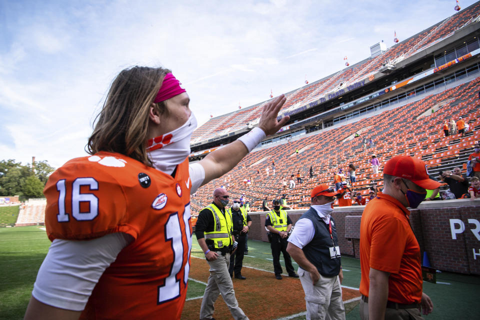 Clemson quarterback Trevor Lawrence (16) waves to fans after an NCAA college football game against Syracuse in Clemson, S.C., on Saturday, Oct. 24, 2020. (Ken Ruinard/Pool Photo via AP)