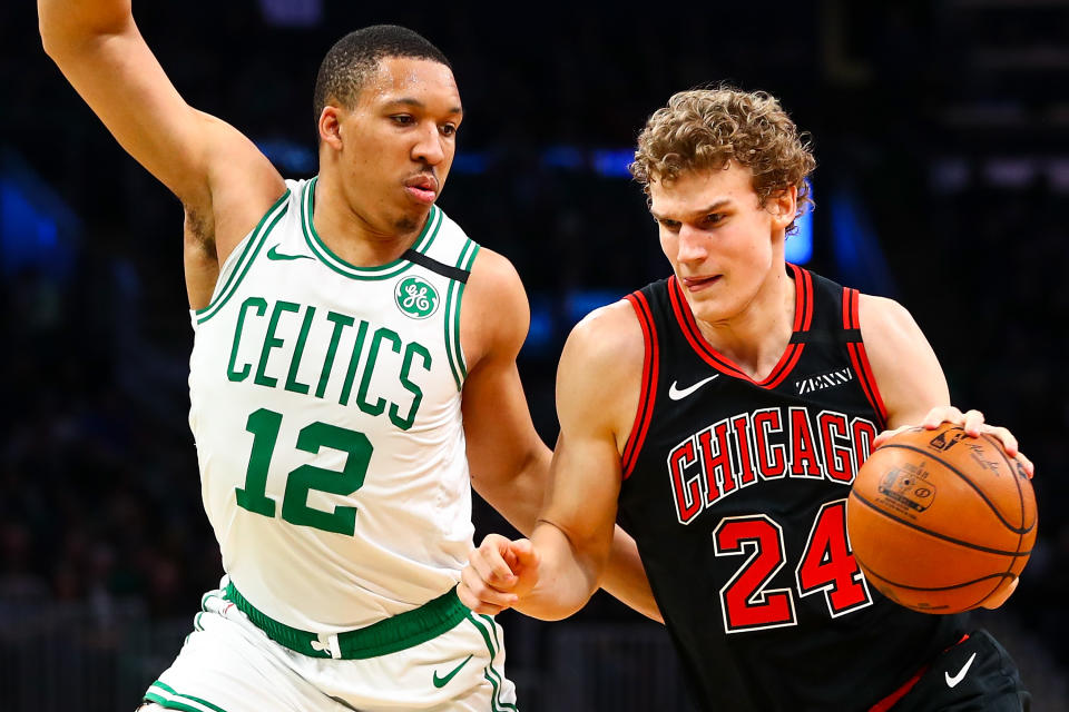 BOSTON, MA - JANUARY 13:  Lauri Markkanen #24 of the Chicago Bulls drives to the basket while guarded by Grant Williams #12 of the Boston Celtics during a game at TD Garden on January 13, 2019 in Boston, Massachusetts. NOTE TO USER: User expressly acknowledges and agrees that, by downloading and or using this photograph, User is consenting to the terms and conditions of the Getty Images License Agreement. (Photo by Adam Glanzman/Getty Images)