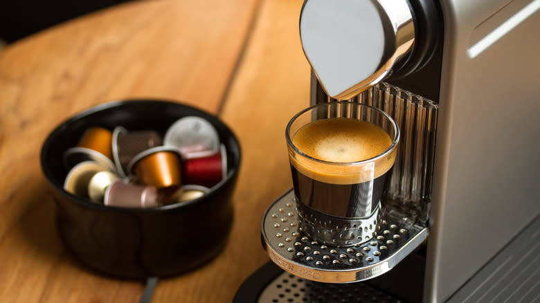 nespresso capsules and machine brewing coffee