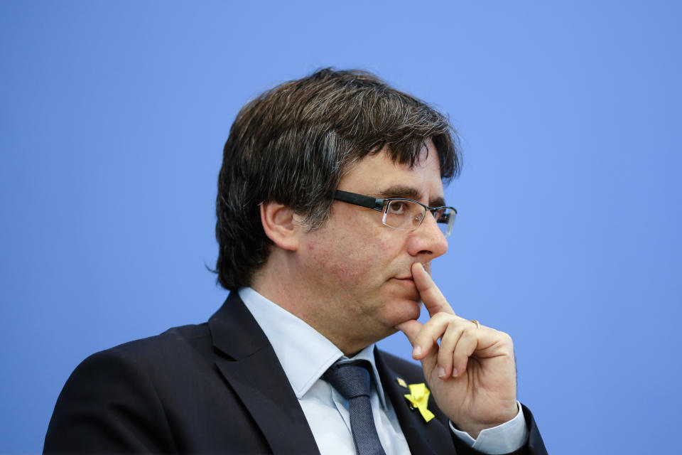 Former Catalan leader Carles Puigdemont, center, attends a news conference in Berlin, Germany, Wednesday, July 25, 2018. (AP Photo/Markus Schreiber)