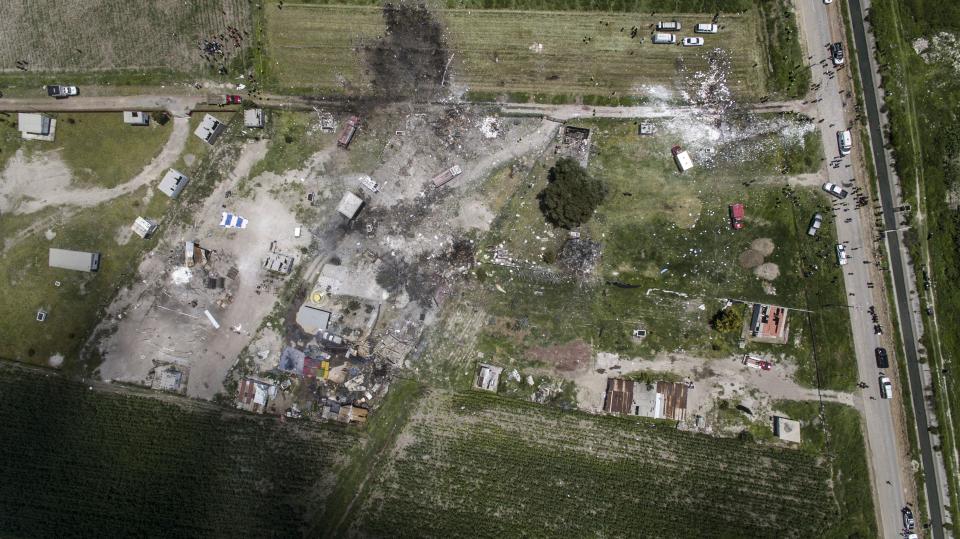 <p>Aerial view of the site of a series of explosions at fireworks warehouses in Tultepec, central Mexico, on July 5, 2018. – At least 17 people were killed, including rescue workers who died saving others’ lives, officials said. The initial explosion occurred around 9:30 am (1430 GMT), then spread to other warehouses just as police and firefighters began attending to the first victims. (Photo: Pedro Pardo/AFP/Getty Images) </p>