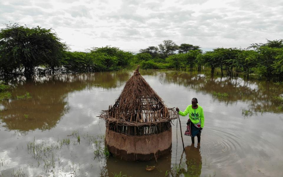 Farmer Parsaalach Nachaki, stands in the field where her house used to stand and is now submerged in rising water due to months of unusually heavy rains in lake Baringo, Kenya, - Baz Ratner/Reuters