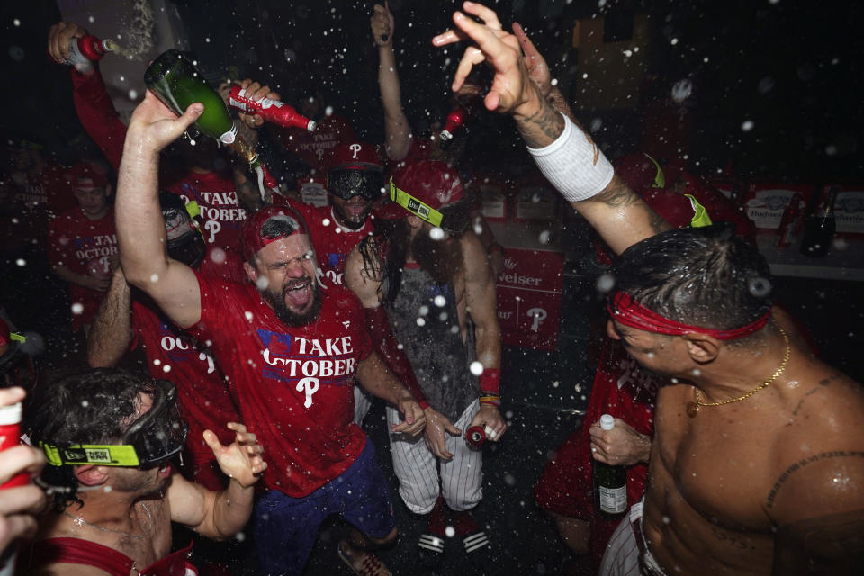 Philadelphia Phillies' Garrett Stubbs, from left, Kyle Schwarber, Brandon Marsh and Nick Castellanos celebrate after the Phillies won an NL wild-card baseball playoff series against the Miami Marlins, Wednesday, Oct. 4, 2023, in Philadelphia. (AP Photo/Matt Slocum)