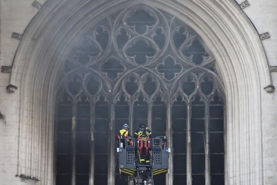 Fire fighters brigade work to extinguish the blaze at the Gothic St. Peter and St. Paul Cathedral, in Nantes, western France, Saturday, July 18, 2020. The fire broke, shattering stained glass windows and sending black smoke spewing from between its two towers of the 15th century, which also suffered a serious fire in 1972. The fire is bringing back memories of the devastating blaze in Notre Dame Cathedral in Paris last year that destroyed its roof and collapsed its spire and threatened to topple the medieval monument. (AP Photo/Romain Boulanger)