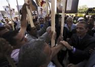 Gamal al-Sadat (R), son of late President Anwar Sadat, shakes hands with people and supporters of the army at his father's tomb, during the 40th anniversary of Egypt's attack on Israeli forces in the 1973 war, at Cairo's Nasr City district, October 6, 2013. REUTERS/Amr Abdallah Dalsh