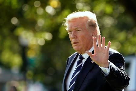 U.S. President Donald Trump waves as he walks on South Lawn of the White House before his departure to Greer, South Carolina, in Washington, U.S., October 16, 2017. REUTERS/Yuri Gripas