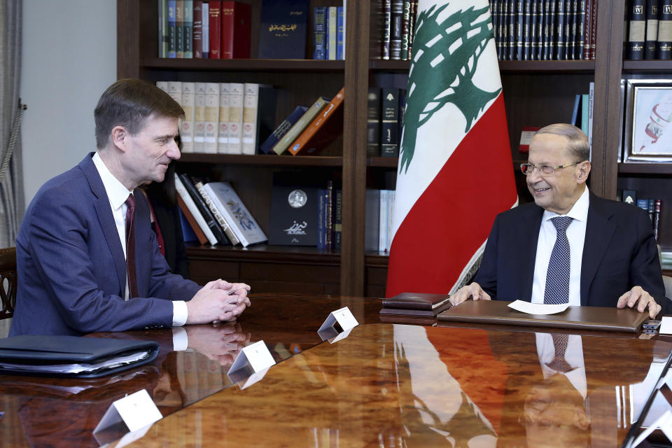 In this photo released by Lebanon's official government photographer Dalati Nohra, Lebanese President Michel Aoun, right, meets with U.S. Undersecretary of State for Political Affairs David Hale, left, at the presidential palace, in Baabda, east of Beirut, Lebanon, Monday, Oct. 21, 2019. Hale was traveling to Beirut, the most senior foreign diplomat to visit the country since the crisis. U.S. diplomats have said they support the quick formation of a government that can bring about reform. (Dalati Nohra via AP)