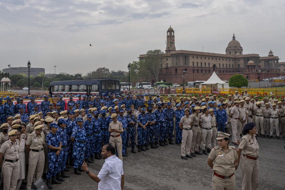 Indian paramilitary soldiers and police officers stand guard at a barricade to prevent lawmakers from India's opposition Congress party from moving ahead during a protest against the Narendra Modi-led government alleging that Indian democracy is in danger, during a protest outside India's parliament in New Delhi, India, Friday, March 24, 2023. Key Indian opposition Congress party leader Rahul Gandhi lost his parliamentary seat as he was disqualified following his conviction by a court that found him of guilty of defamation over his remarks about Prime Minister Narendra Modi's surname, a parliamentary notification said on Friday. (AP Photo/Altaf Qadri)