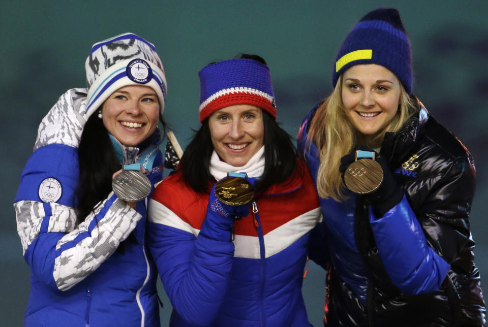 <p>From left, Finland’s Krista Parmakoski, silver, Norway’s Marit Bjoergen, gold, and Sweden’s Stina Nilsson, bronze, pose for photos during the medals ceremony for the women’s 30k cross-country skiing at the closing ceremony of the 2018 Winter Olympics in Pyeongchang, South Korea, Sunday, Feb. 25, 2018. (AP Photo/Natacha Pisarenko) </p>