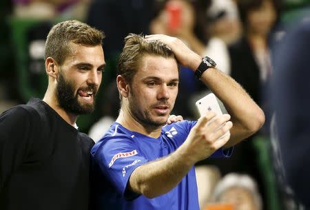 Switzerland's Stan Wawrinka (R) and Benoit Paire of France take a selfie after their men's singles final of the Japan Open tennis championships in Tokyo October 11, 2015. REUTERS/Thomas Peter