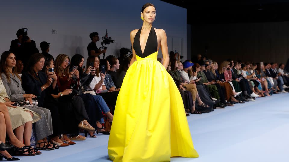 Irina Shayk walked for Carolina Herrera in a plunging halter gown with a burst of canary yellow. - Taylor Hill/WireImage/Getty Images