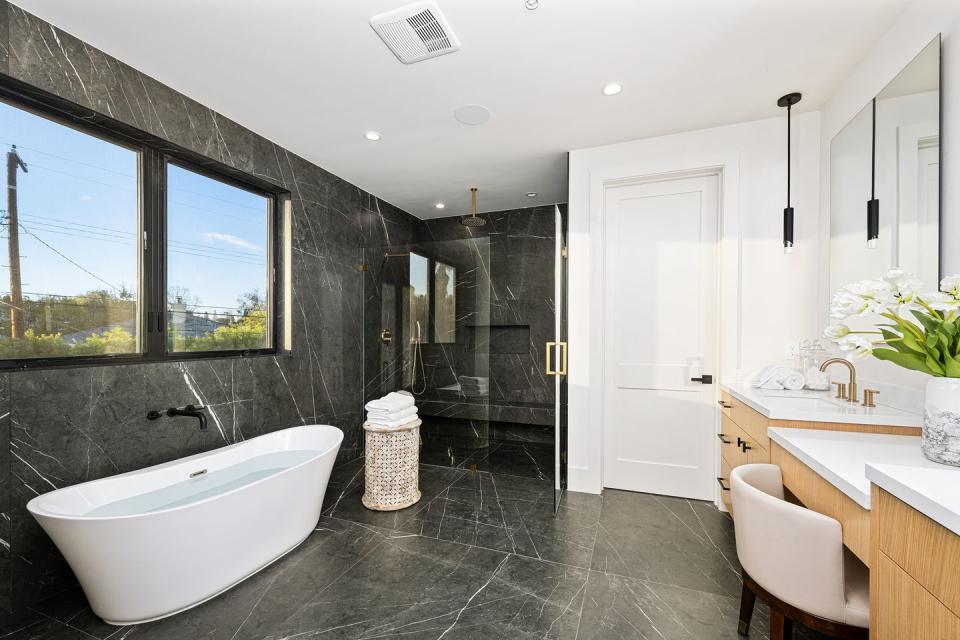 a bathroom with a tub and sink