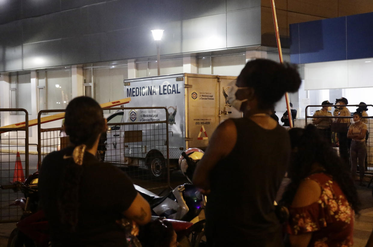 People wait out side the morgue for the bodies of inmates killed in a riot at the Litoral penitentiary in Guayaquil, Ecuador, Wednesday, September 29, 2021. President Guillermo Lasso said in a press conference that the dead are so far 116. (AP Photo/Angel DeJesus)