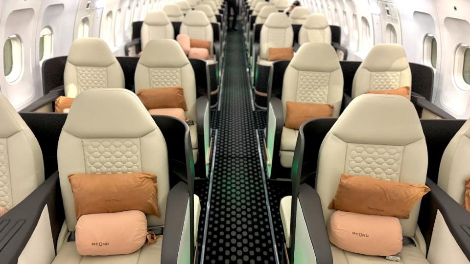 Not a private jet layout, but more spacious than most business classes. All 44 seats are lie-flat for overnight flights.