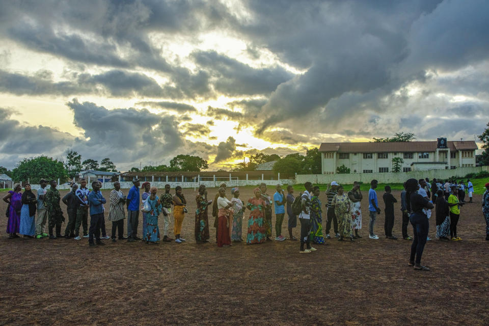 Voters wait for polling stations to open in Sierra Leone general elections in Freetown, Saturday, June 24, 2023. Sierra Leoneans are selecting their next president amid mounting frustration due to an ailing economy, rising unemployment and the loom of deadly protests. (AP Photo/TJ Bade)