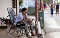 Yudaris Aleman speaks to her daughter who lives in Canada, via a mobile device in Varadero, Cuba, December 6, 2018. Picture taken on December 6, 2018. REUTERS/Fernando Medina