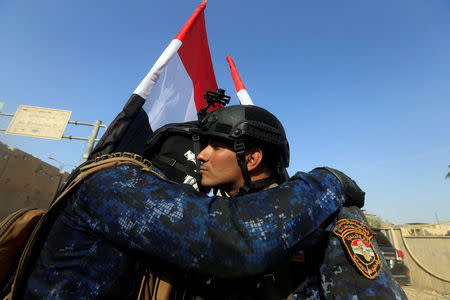 Iraqi Federal police hug each other as they celebrate in West Mosul, Iraq July 9, 2017. REUTERS/Alaa Al-Marjani