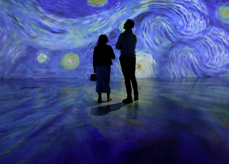 Guests explore 'Beyond Van Gogh: The Immersive Experience' during a preview event at the Resch Expo in Ashwaubenon, Wis.