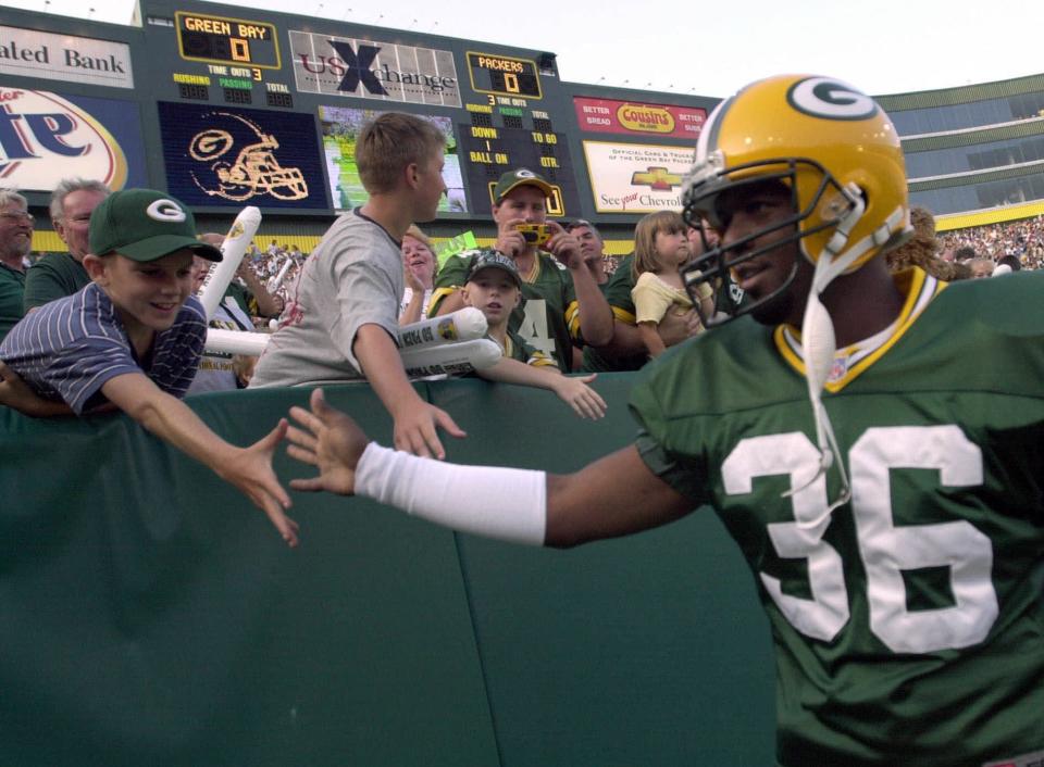 Green Bay Packers safety LeRoy Butler greets fans as he takes the field Saturday night, July 29, 2000, at Lambeau Field in Green Bay, Wis., before the Packers' intrasquad scrimage. (AP Photo/Mike Roemer)
