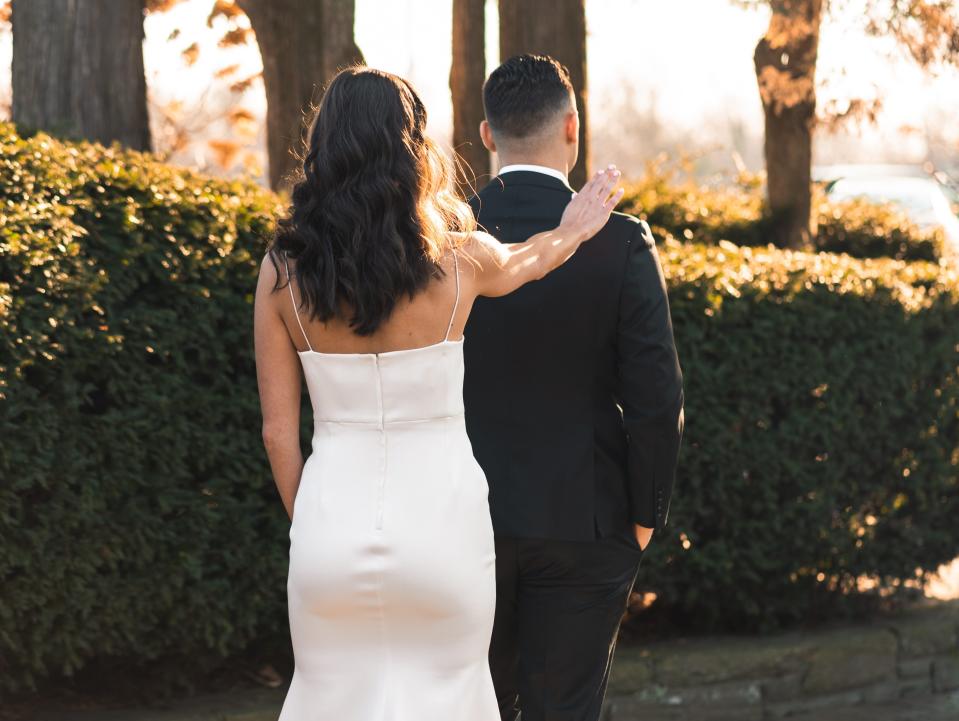 bride tapping her grooms shoulder for a first look at their wedding