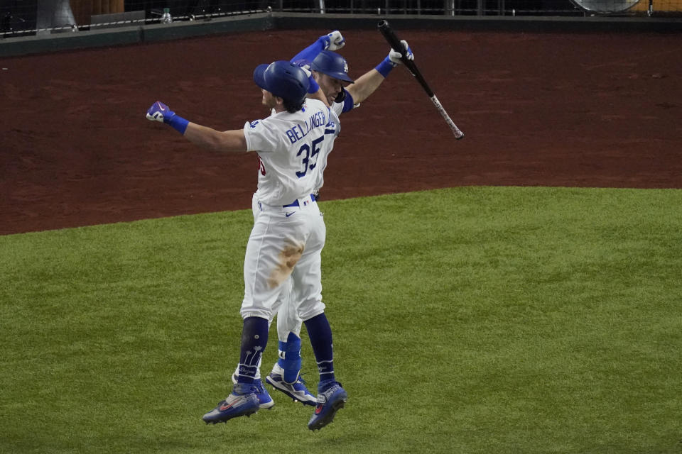 Los Angeles Dodgers' Cody Bellinger celebrates his home run with A.J. Pollock against the Atlanta Braves during the seventh inning in Game 7 of a baseball National League Championship Series Sunday, Oct. 18, 2020, in Arlington, Texas. (AP Photo/Sue Ogrocki)