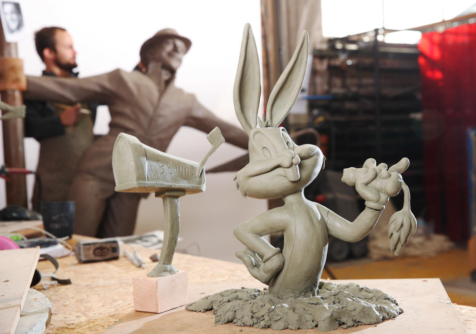 Sculptor Andrzej Szymczyk adds finishing touches to statues of Bugs Bunny and Gene Kelly, which will soon be installed around Leicester Square gardens.