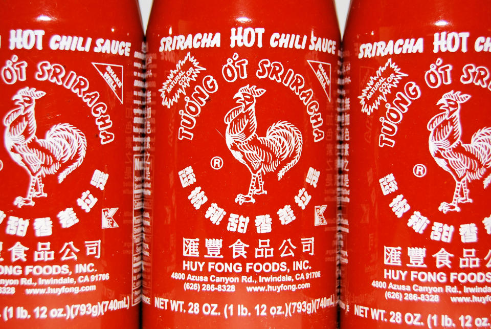 Three bottles of Sriracha hot chili sauce with the rooster logo